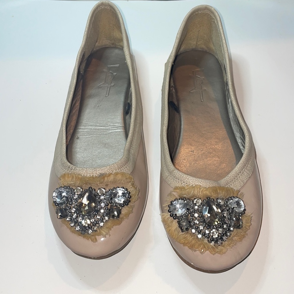 Nude round toe flats with gem detailing on toe. Size 6 US